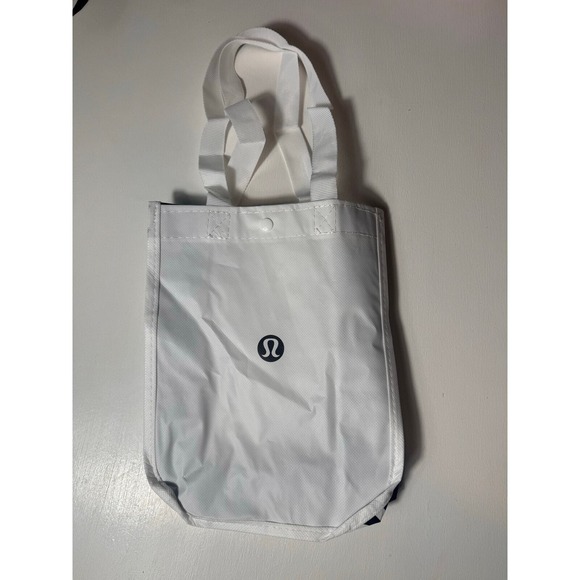 lululemon athletica Handbags - NWOT Lululemon White & Black ‎ Reusable Tote Bag with button clap to close
